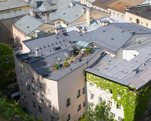 Creative use of a flat roof: terrace with plants and accessories. Aerial view of Salzburg, Austria.
